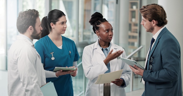 A healthcare team meets in a hallway